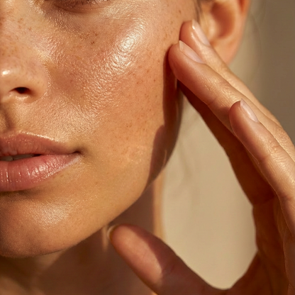 Close-up of a person's face with hand near ear, focusing on skin texture.